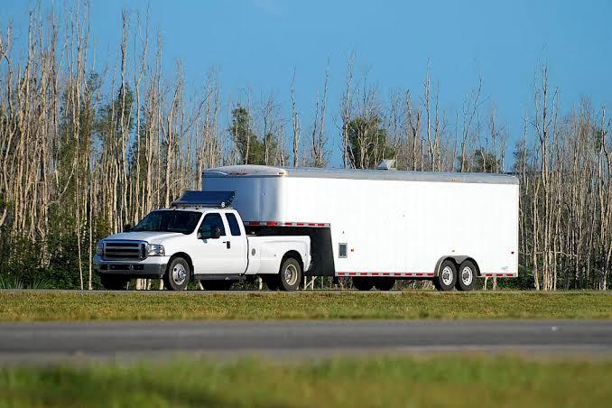 Pickup truck pulling a gooseneck hotshot trailer